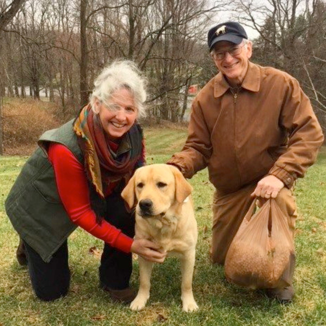 man and woman with yellow lab