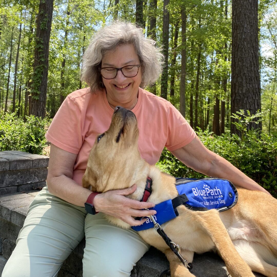 Woman with yellow lab in lap
