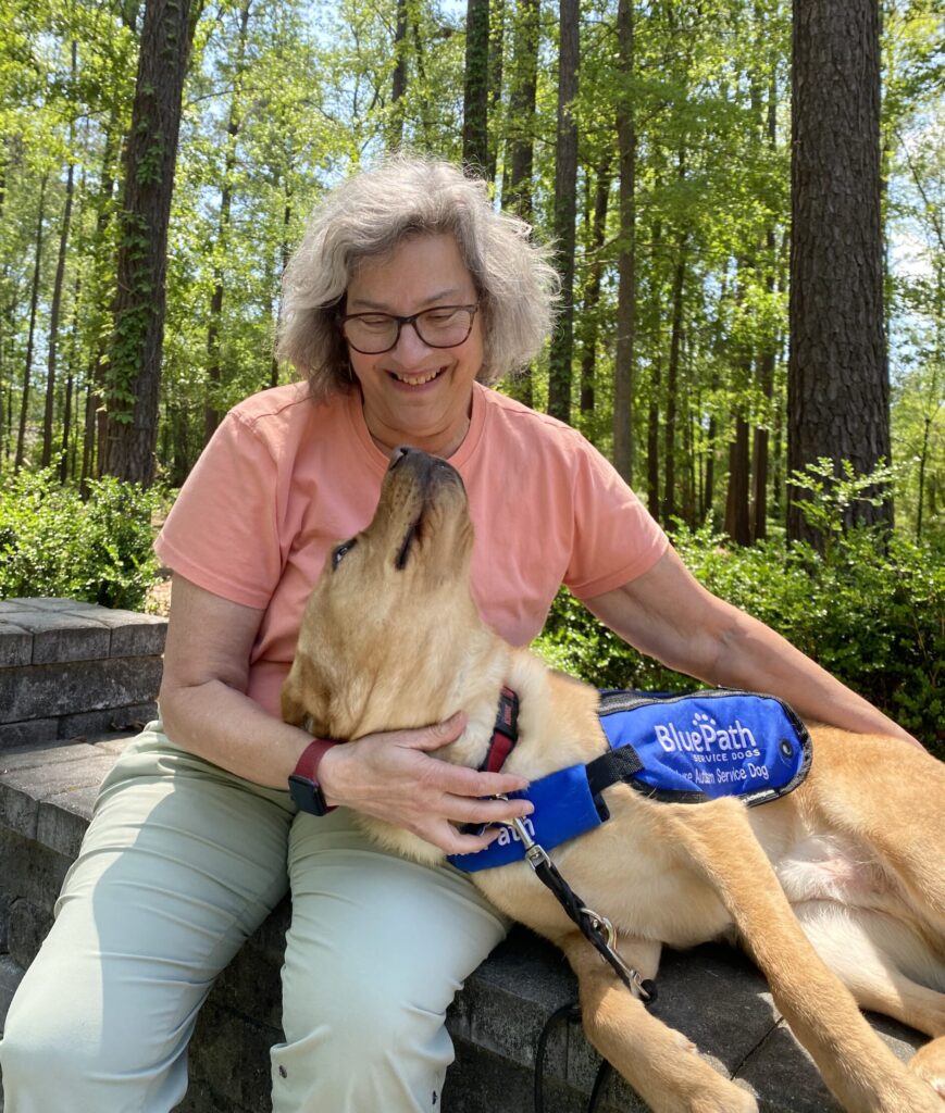 Woman with yellow lab in lap